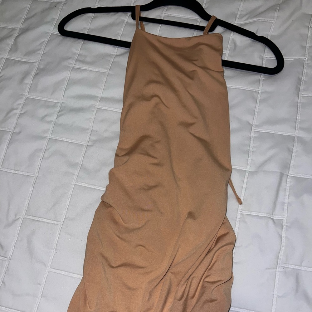 Mini scrunched beige cream dress and strappy backless.